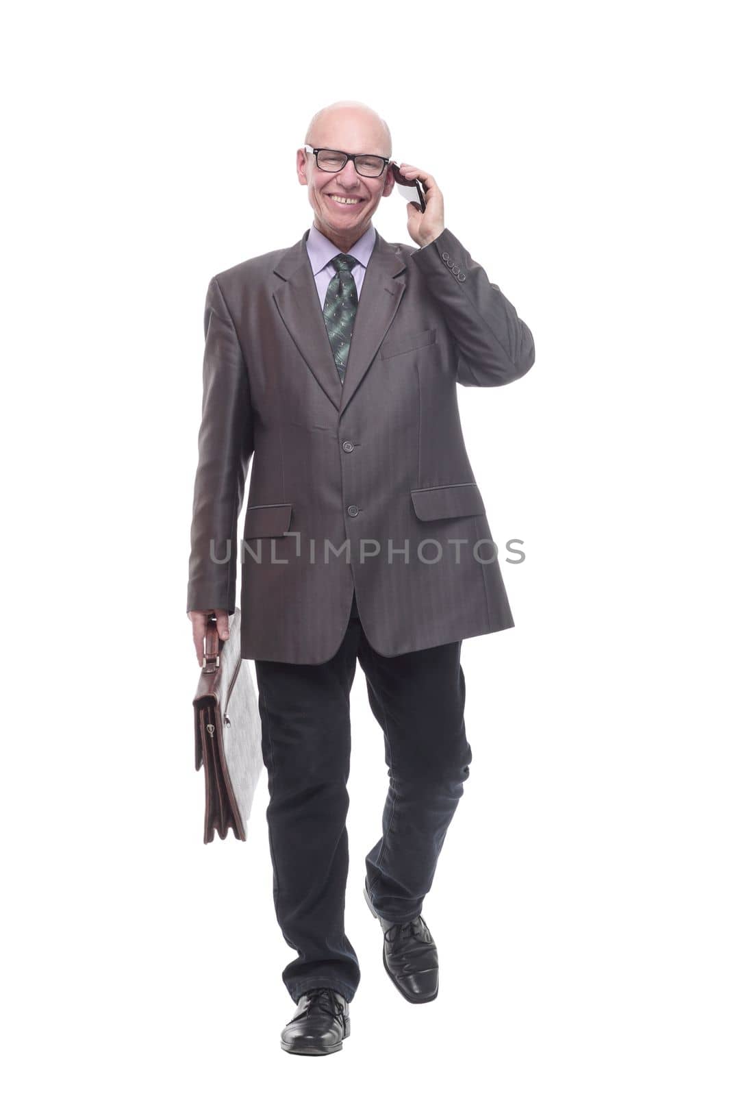in full growth.smiling business man with a smartphone. isolated on a white background.