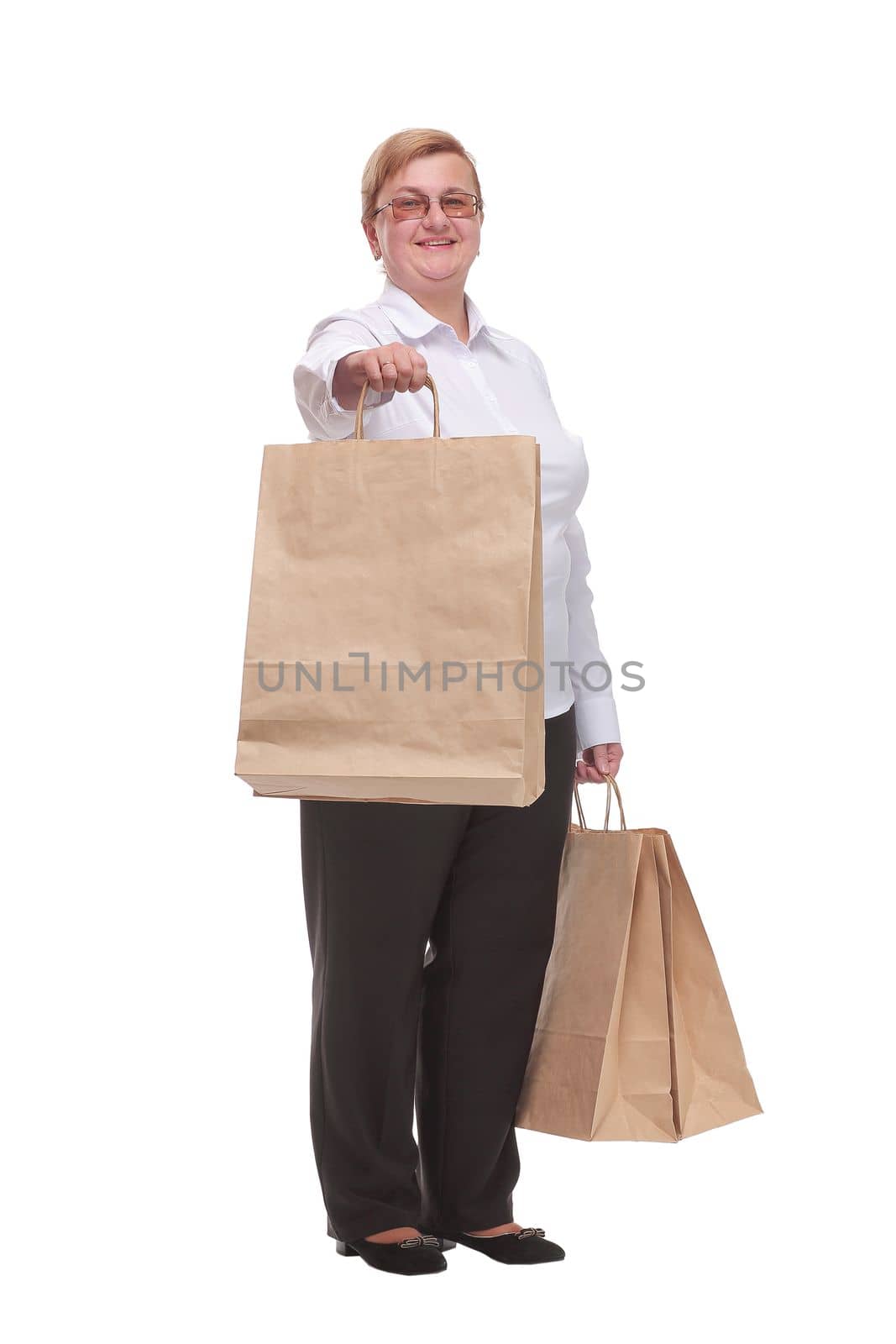 Middle aged woman cheerful and smiling, very excited carrying a shopping bags. Concept of a good shopping