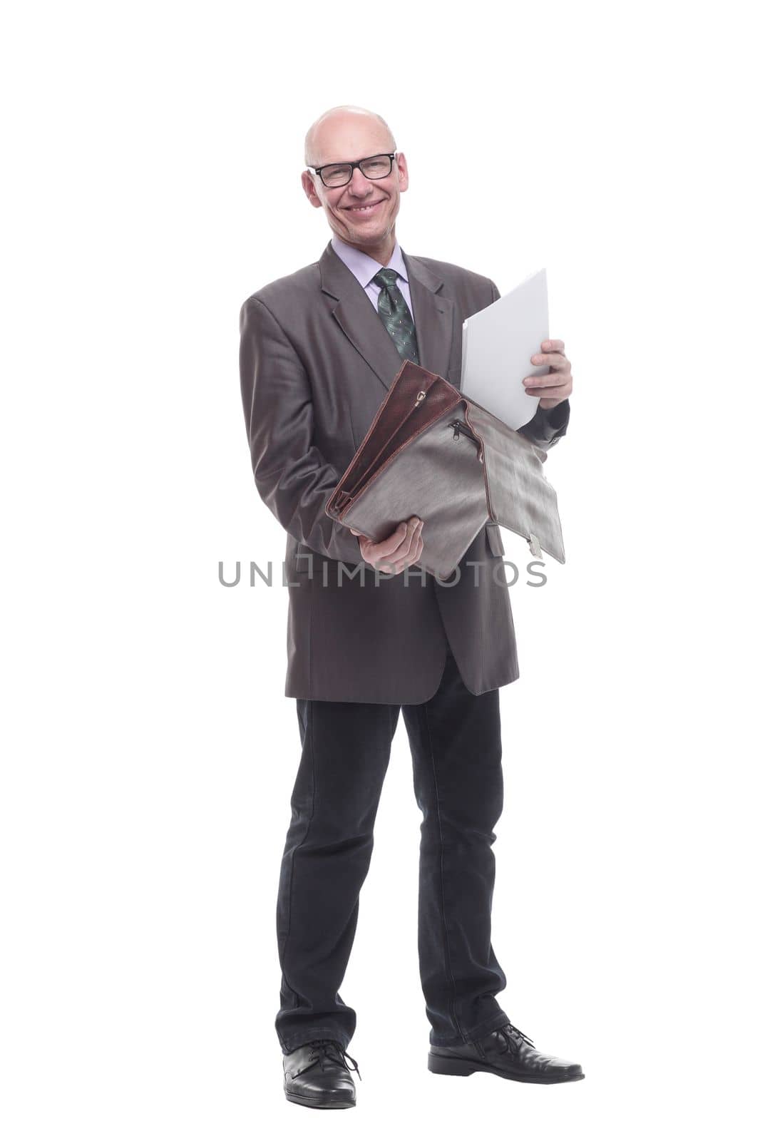 in full growth. business man with a stack of documents. isolated on a white background