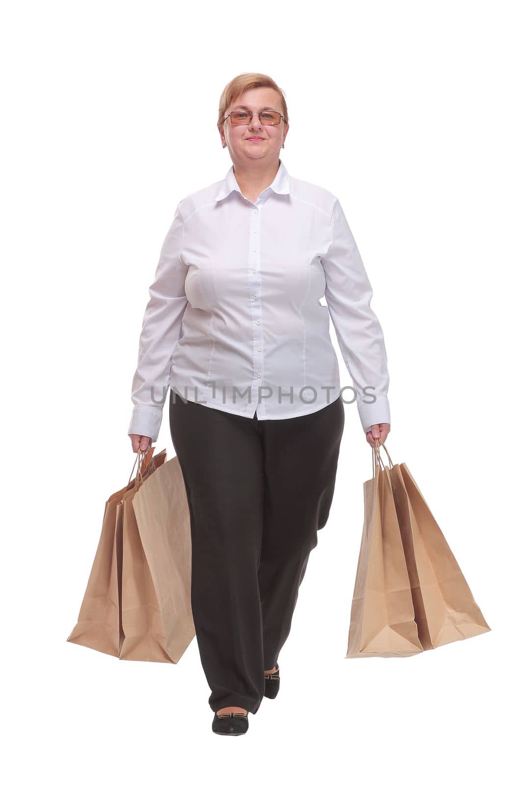 Full length portrait of a woman walking with shopping bags by asdf