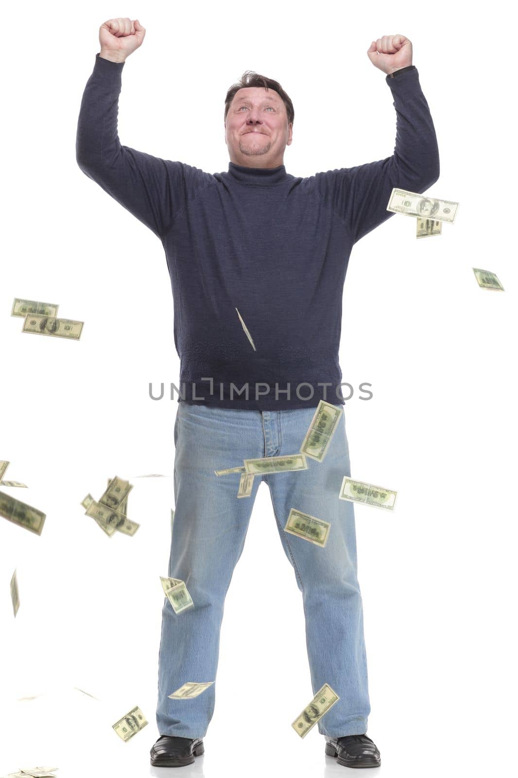 in full growth. happy woman standing in the rain of money.isolated on a white background