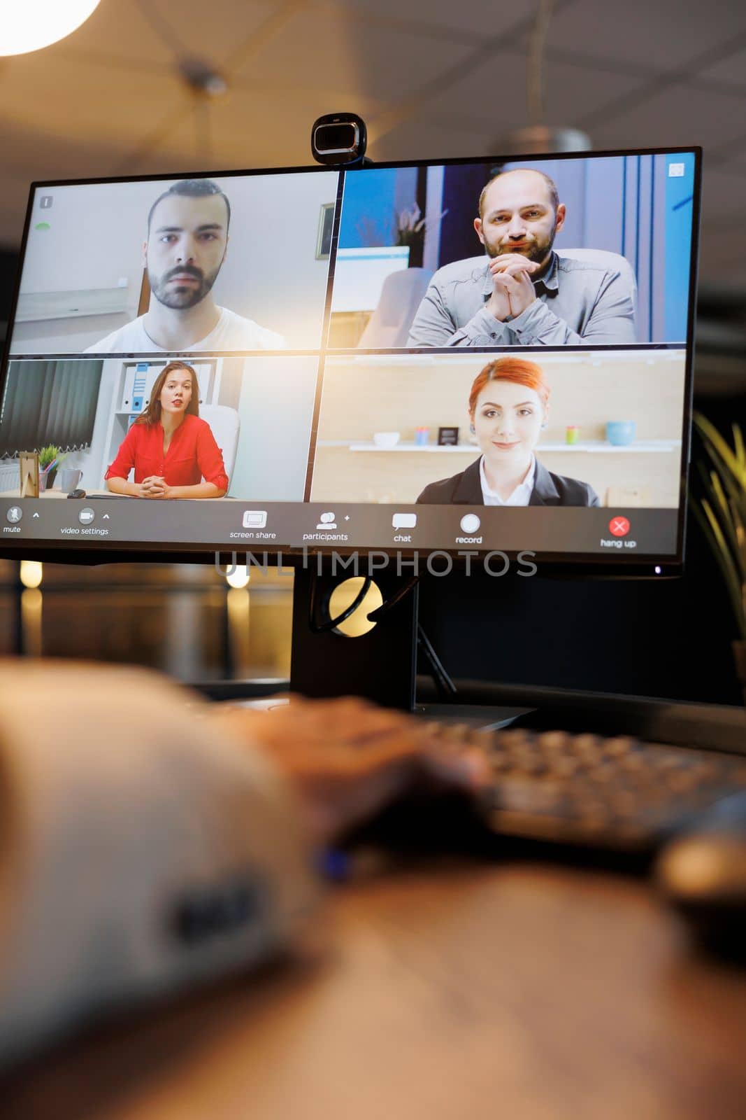 Manager explaining company investment strategy to remote colleagues during online videocall meeting conference. Diverse corporate team working late at night in startup office. Business concept