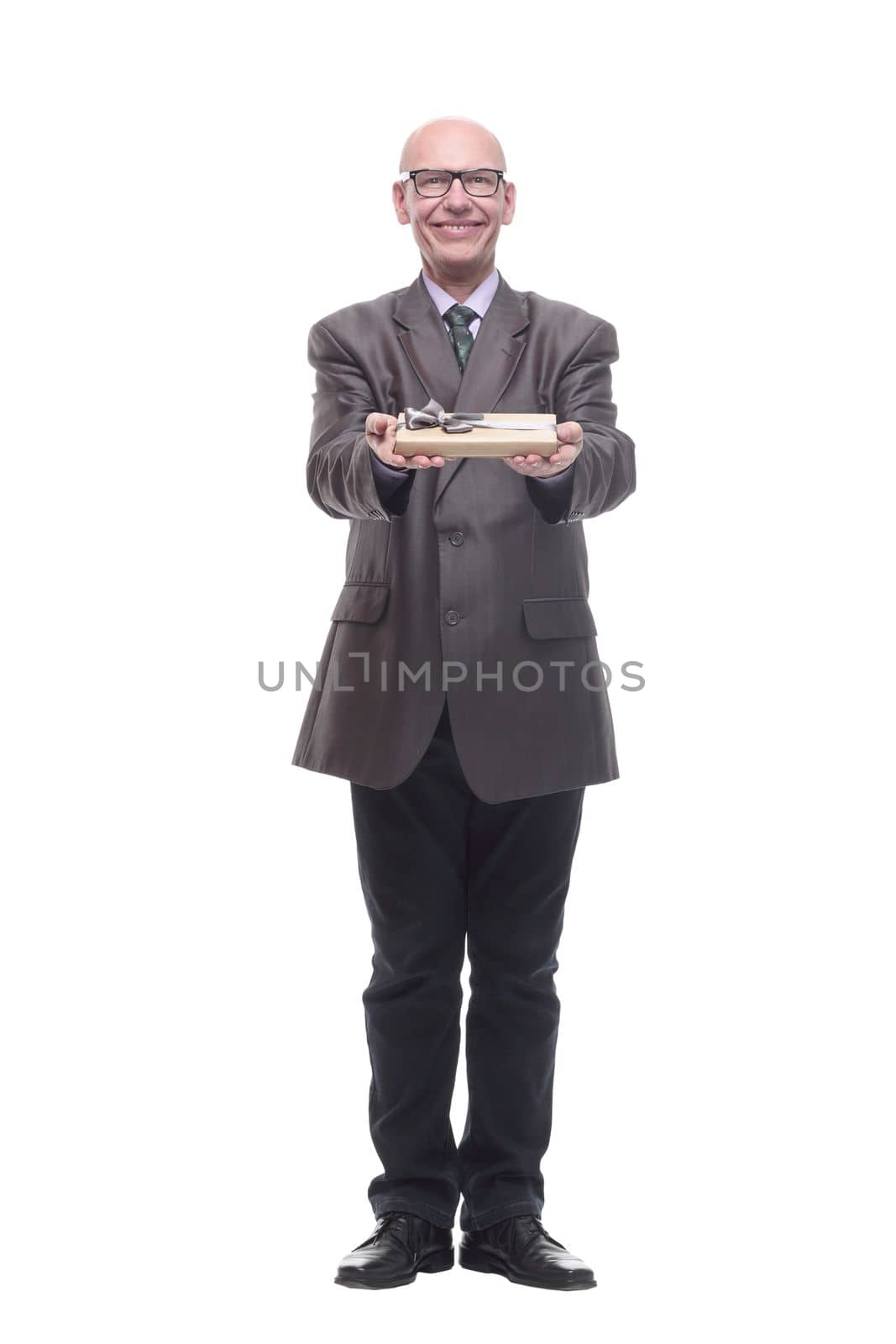 in full growth.business man with a gift box. isolated on a white background.