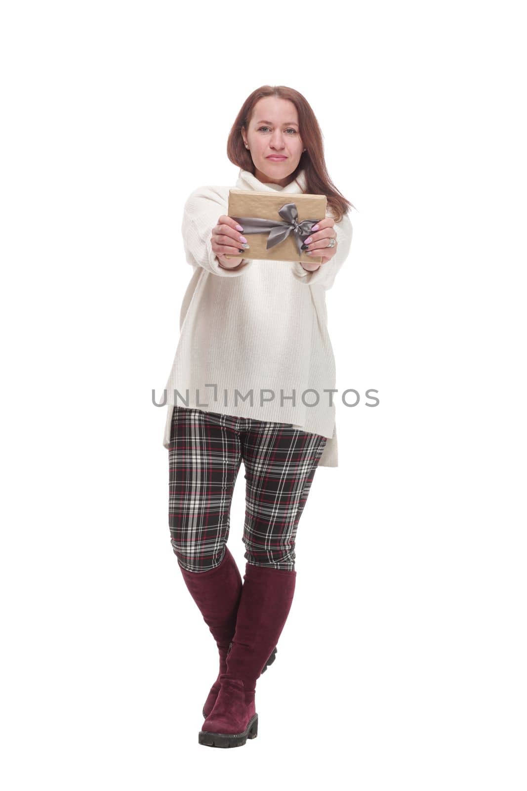 in full growth. attractive casual woman with a gift box .isolated on a white background.