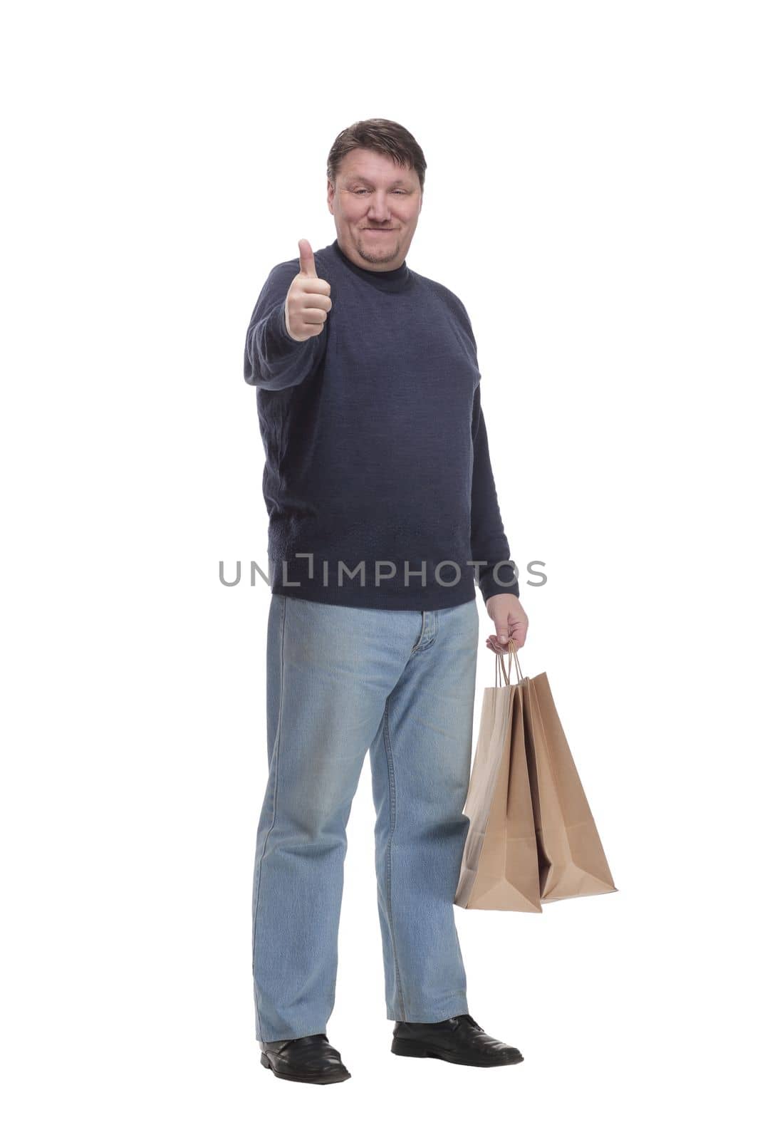 in full growth. mature man with shopping bag.isolated on a white background.