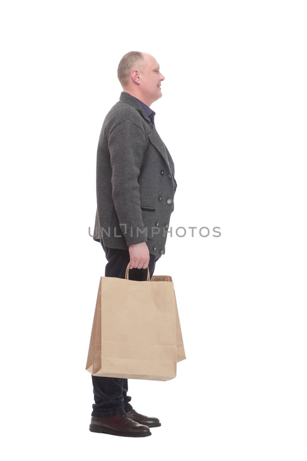 cheerful casual man with shopping bags .isolated on a white background. by asdf