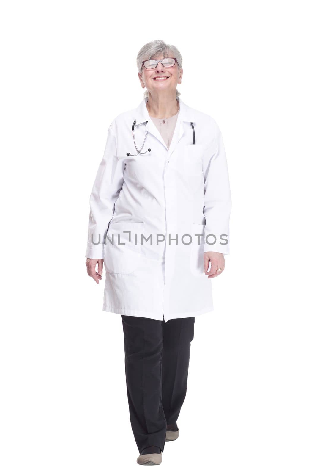 in full growth. happy woman doctor striding forward. isolated on a white background.
