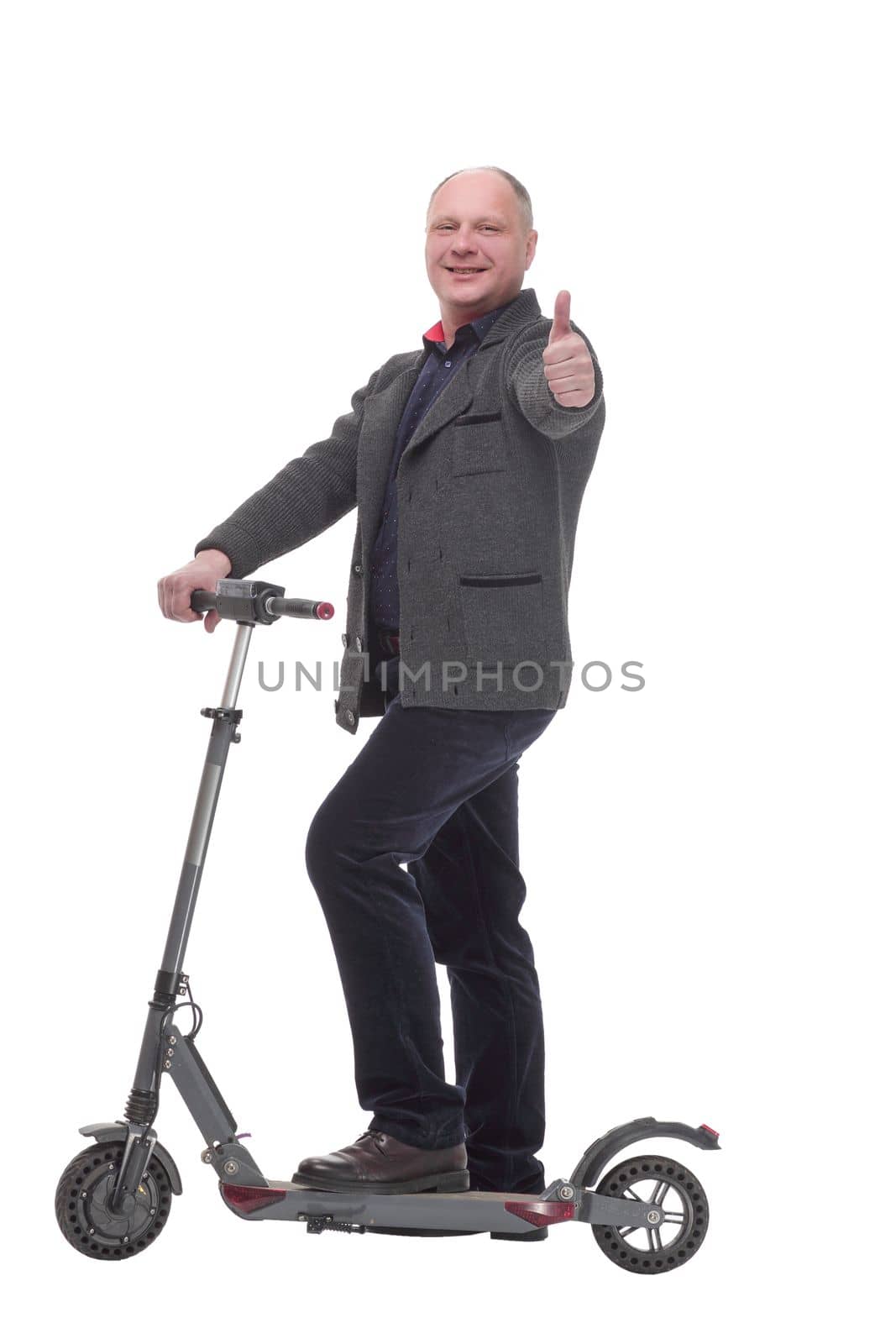 in full growth. happy casual man with electric scooter .isolated on a white background.