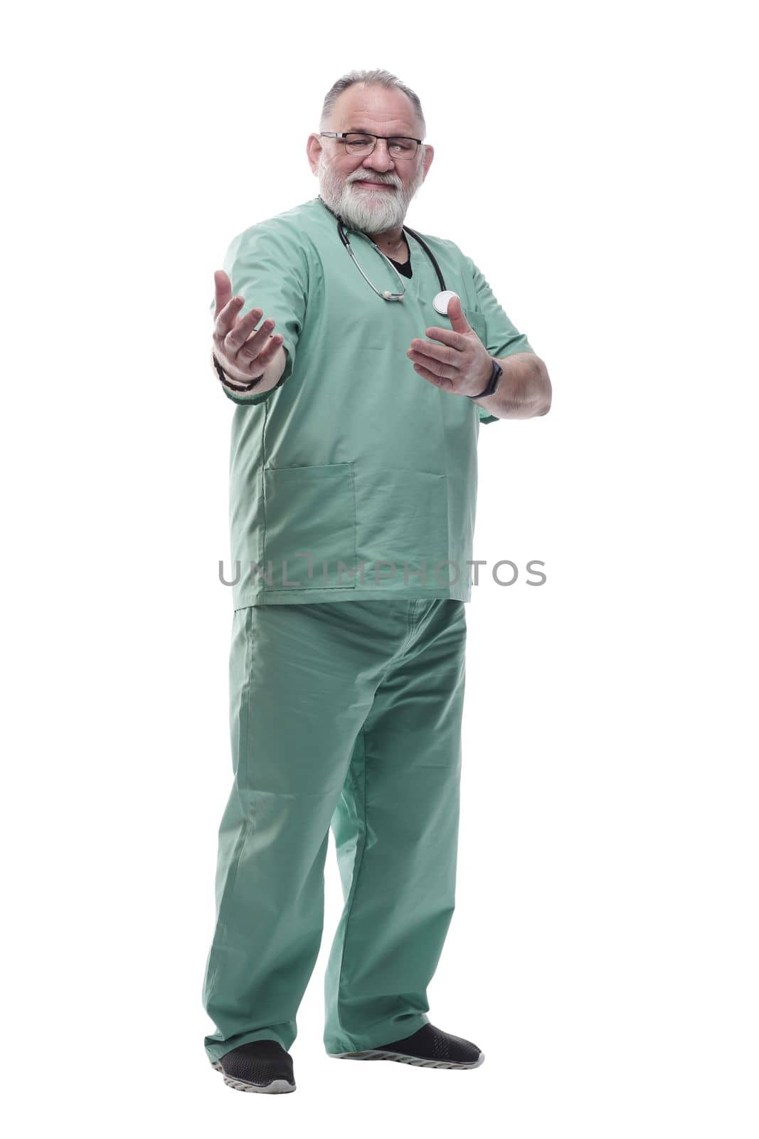 in full growth. smiling adult doctor looking at the camera. isolated on a white background