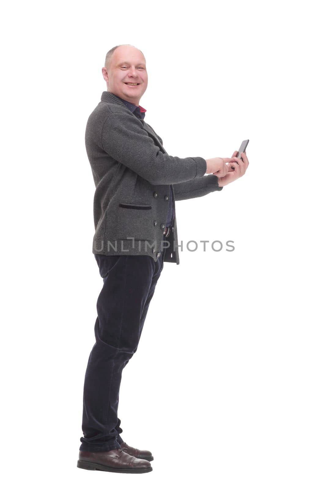 smiling mature man with a smartphone .isolated on a white background. by asdf