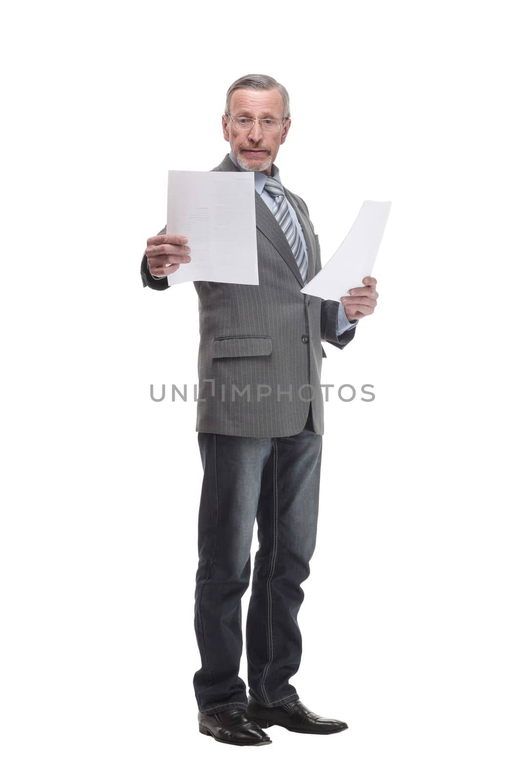 Shot of a senior professional man holding papers in his hand and doing some paperwork while standing at isolated white background.