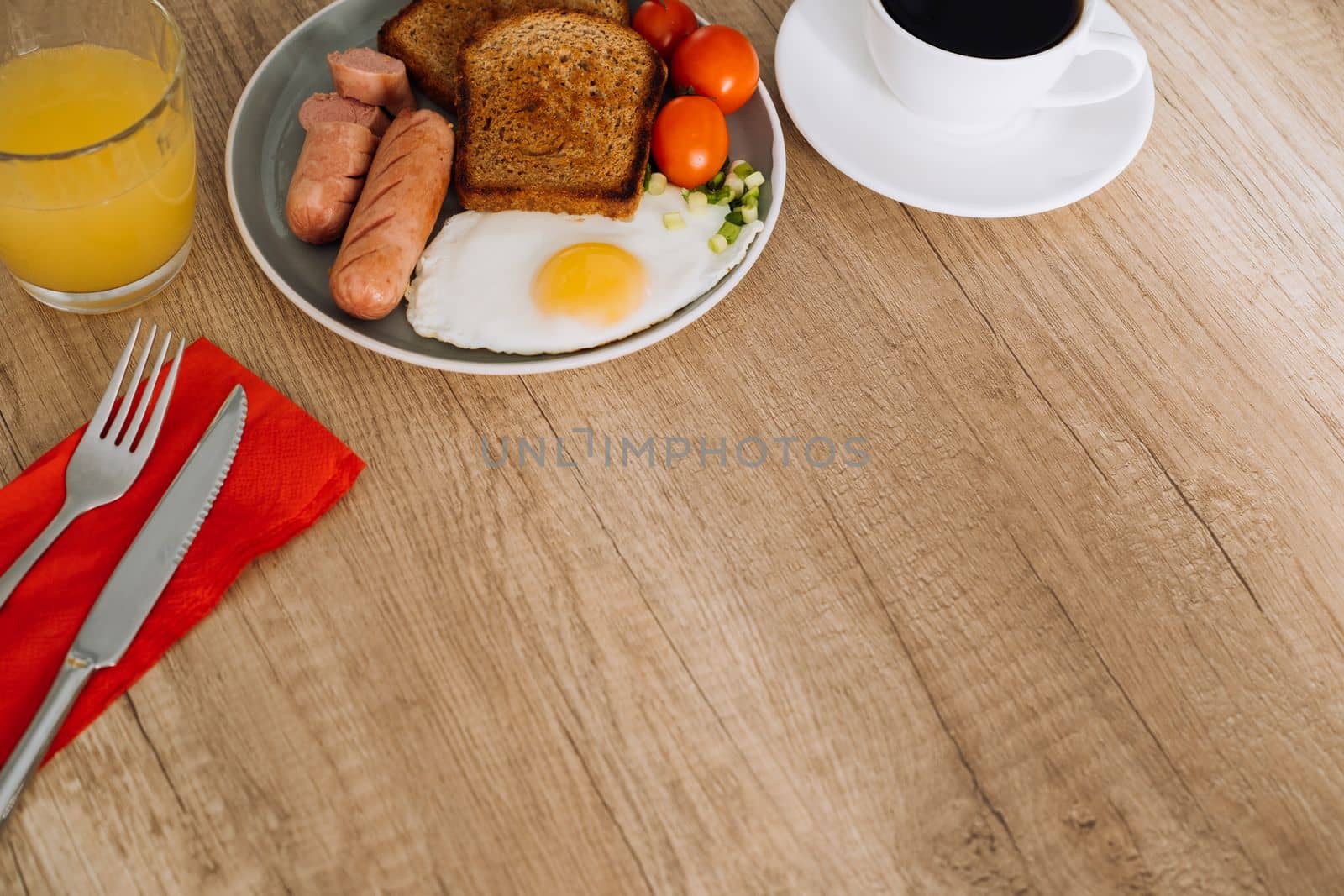 English breakfast with black coffee and orange juice on wooden table with copy space