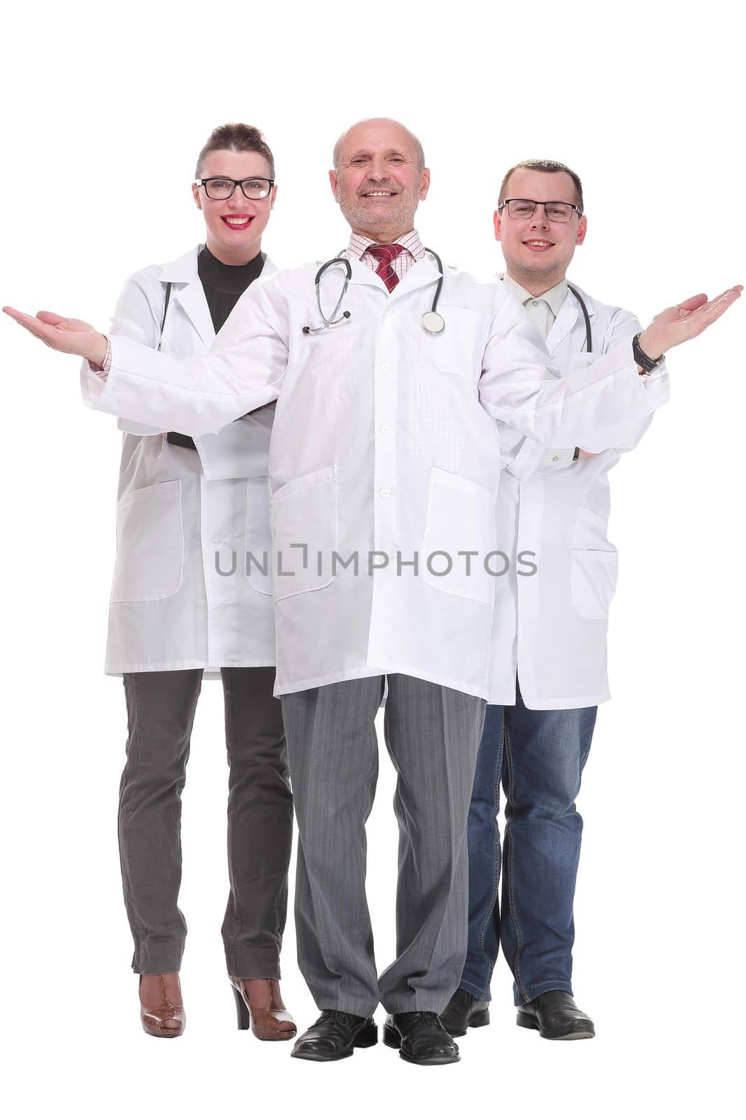 Team of doctors standing arms crossed and smiling at camera. Concept of medical help and confidence