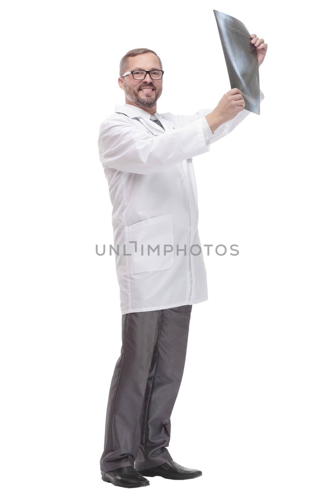 in full growth. competent doctor looking at an x-ray . isolated on a white background.
