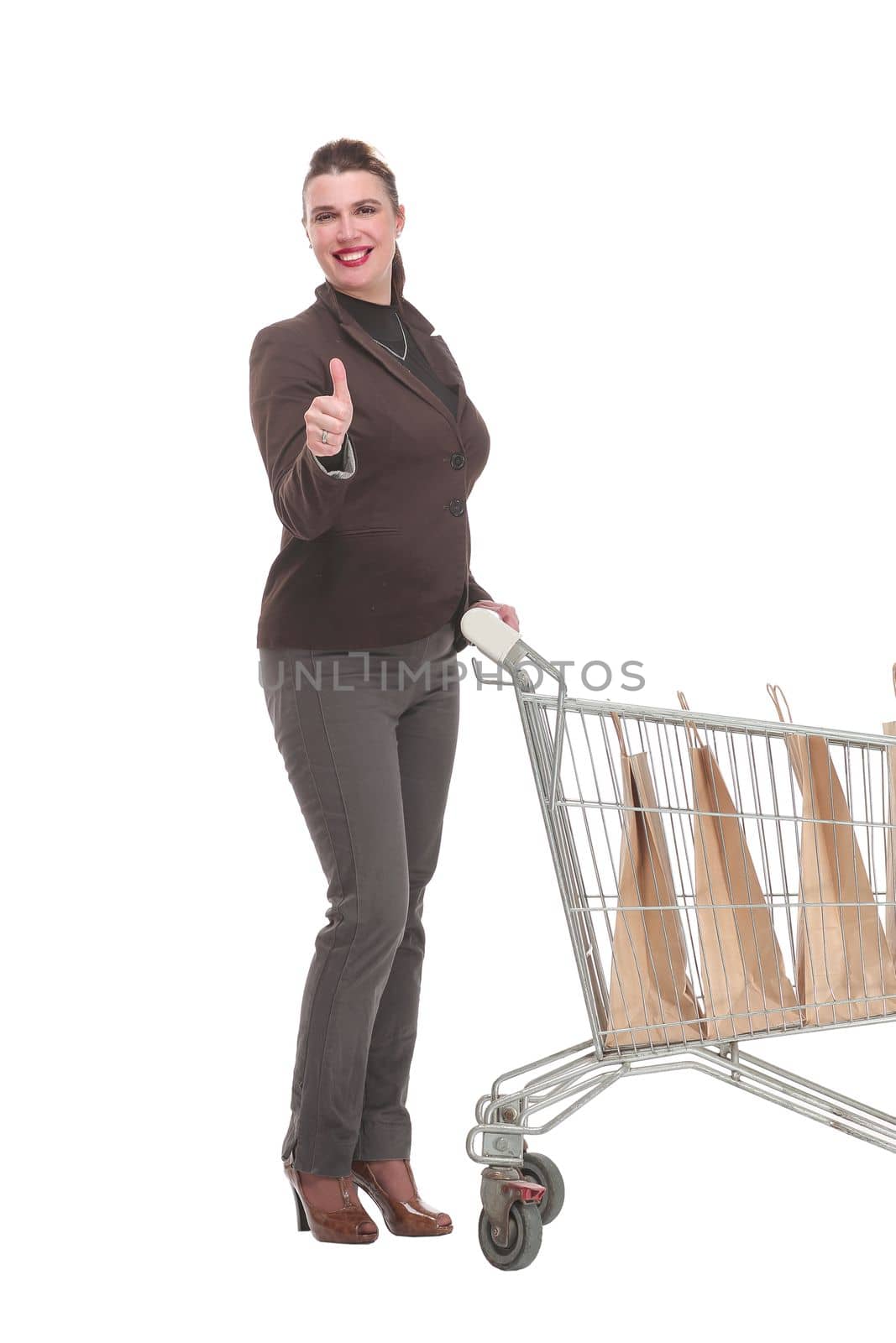 Side view of young woman with shopping cart looking at camera