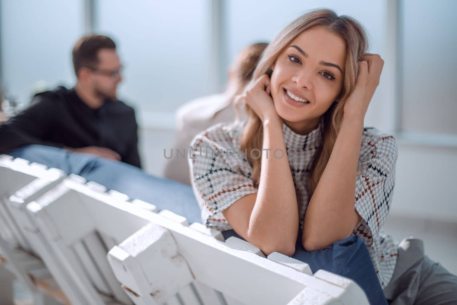 young business woman sitting in office lobby at coffee break. office weekdays
