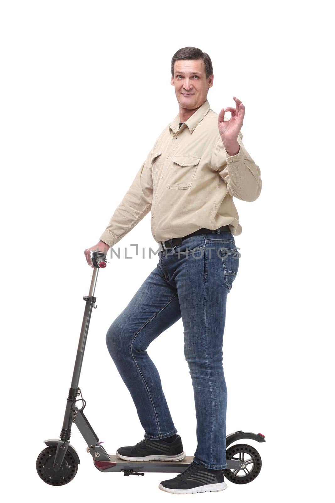 Side view of happy man rides a black kick scooter, isolated on white background