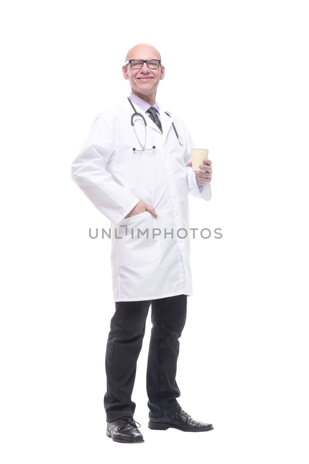 in full growth. smiling doctor with a takeaway coffee. isolated on a white background.