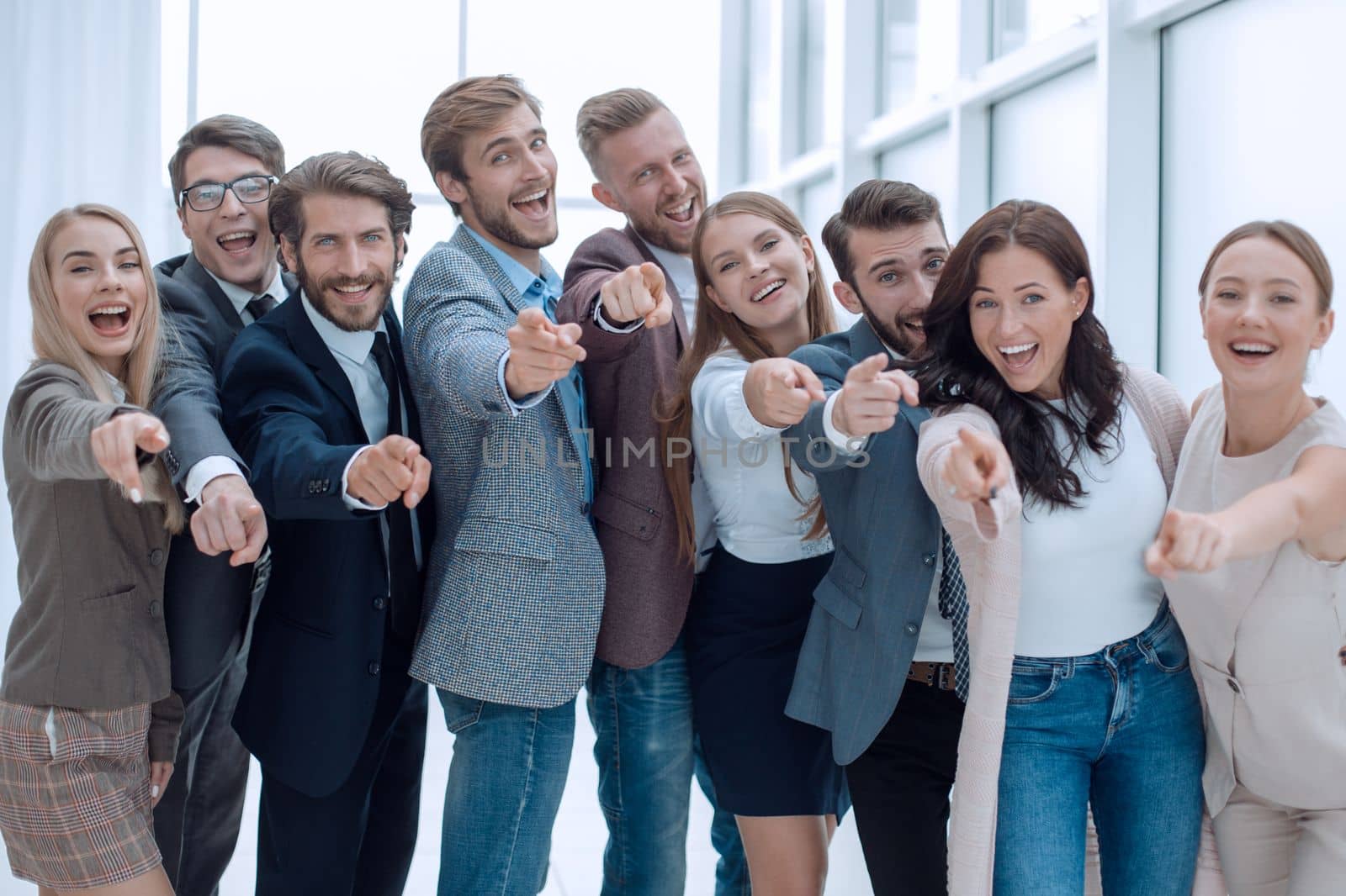 group of successful young people pointing at you by asdf