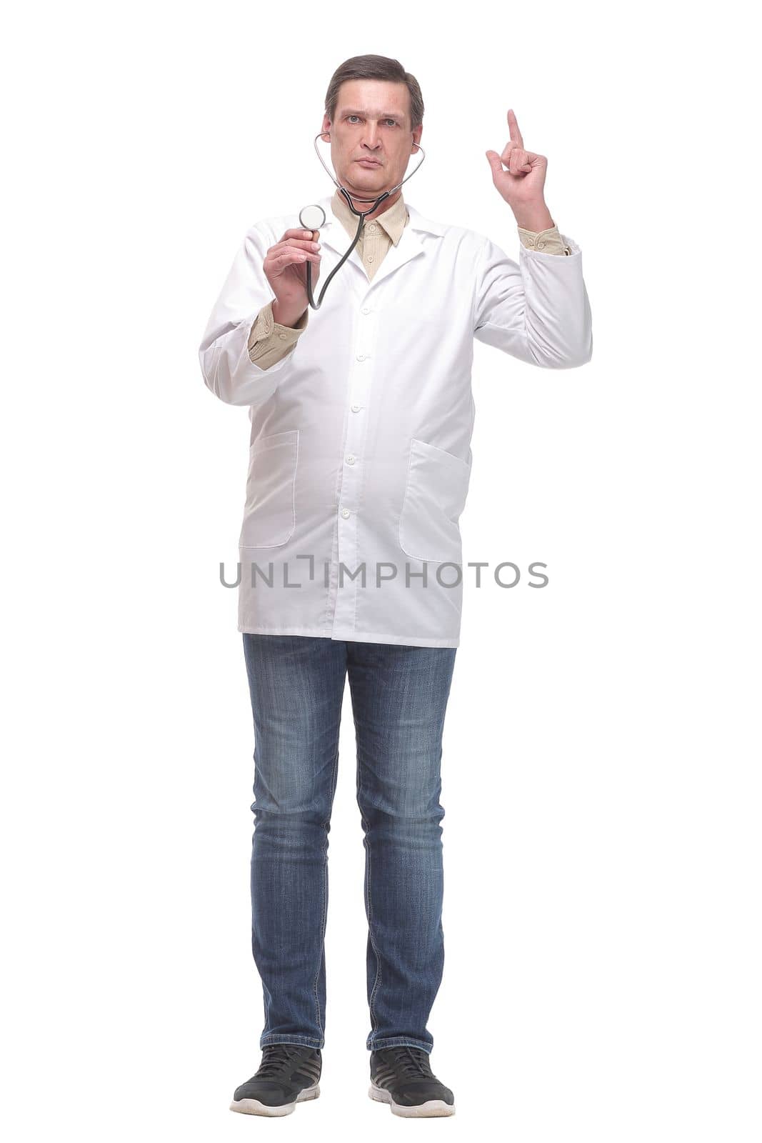 Front view of serious doctor listening to a heartbeat with a stethoscope over white background