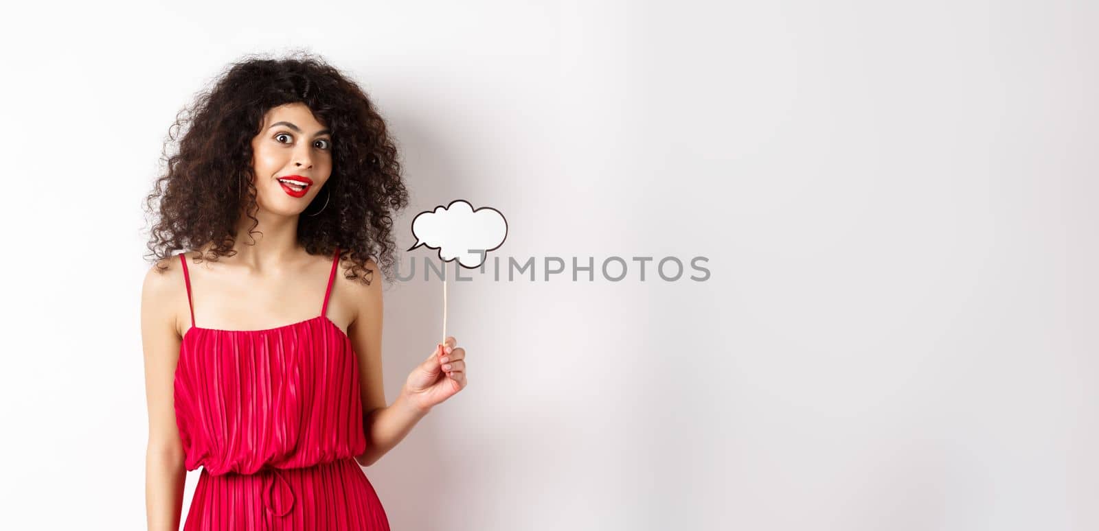 Beautiful woman with curly hair, wearing red dress, holding comment cloud, say something, standing on white background by Benzoix