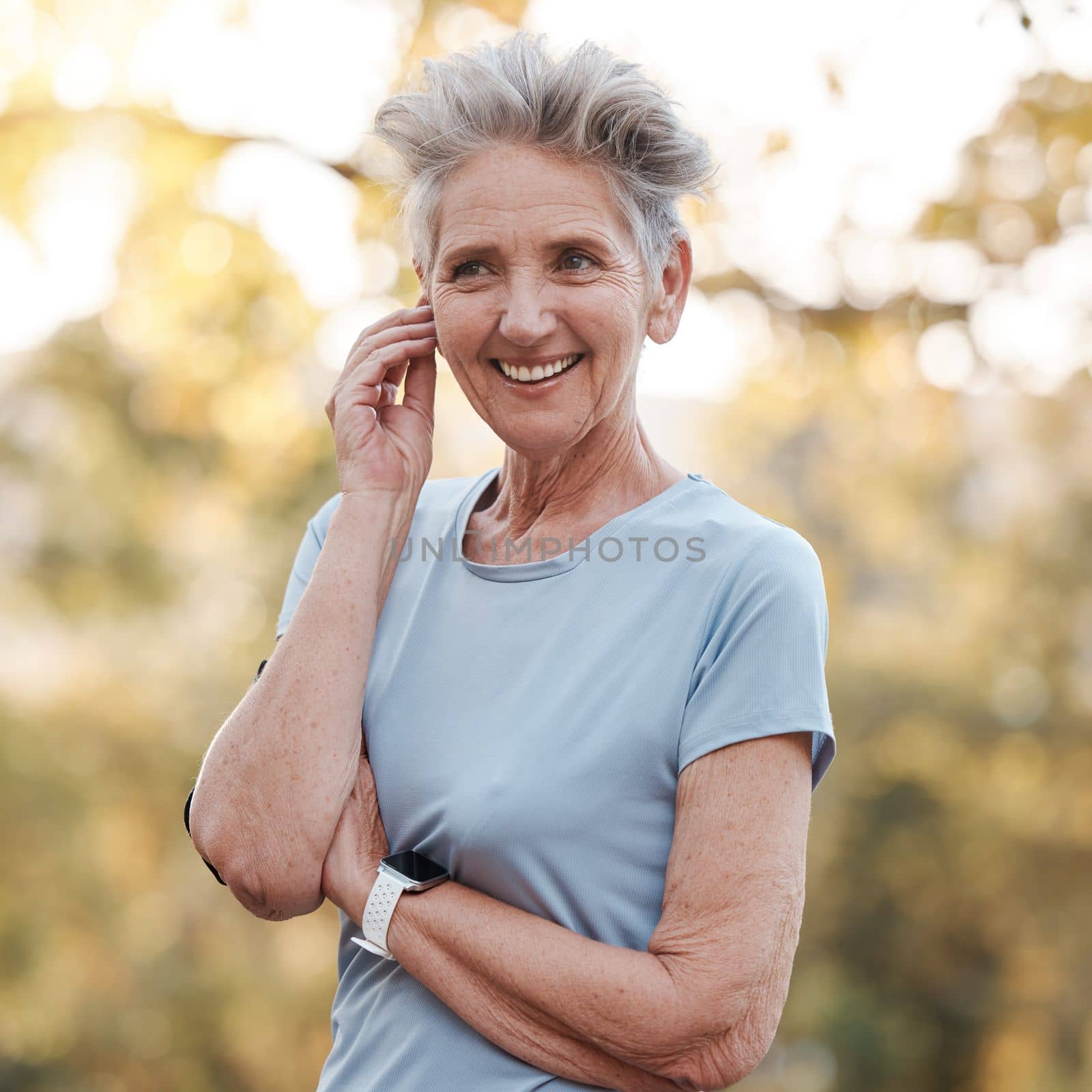Senior woman, happy and smile for outdoor exercise, healthy fitness workout and lifestyle motivation in nature park. Elderly person, happiness and cardio wellness training with bokeh background by YuriArcurs