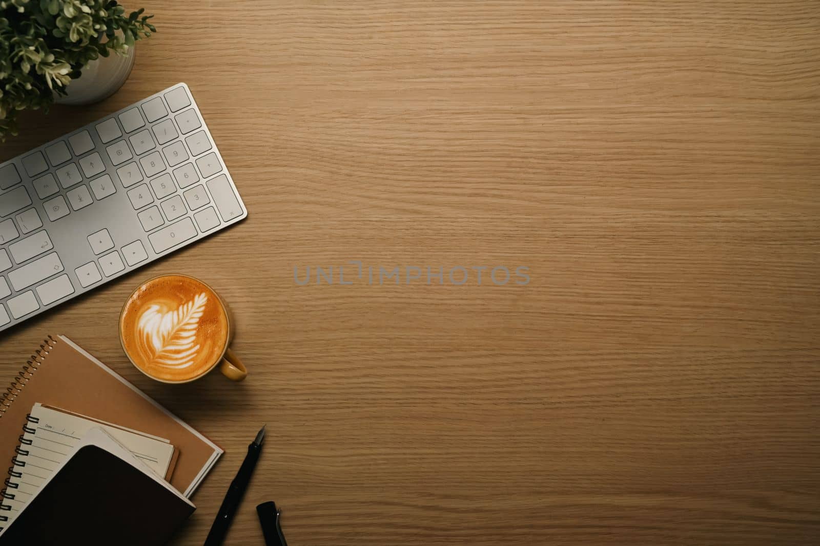 Cup of coffee, books and wireless keyboard on wooden table. Flat lay, top view with copy space by prathanchorruangsak