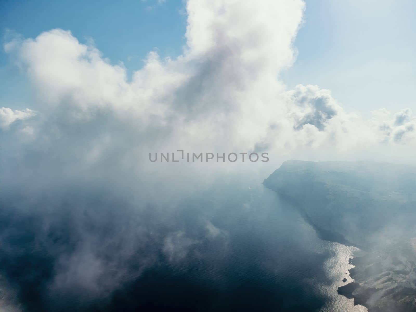 Blue sky with white clouds moving panorama summer. Sea in light of day aerial view of drone slide forward. Small waves on sea. Sunny sunset over the sea. Sun way. Horizon
