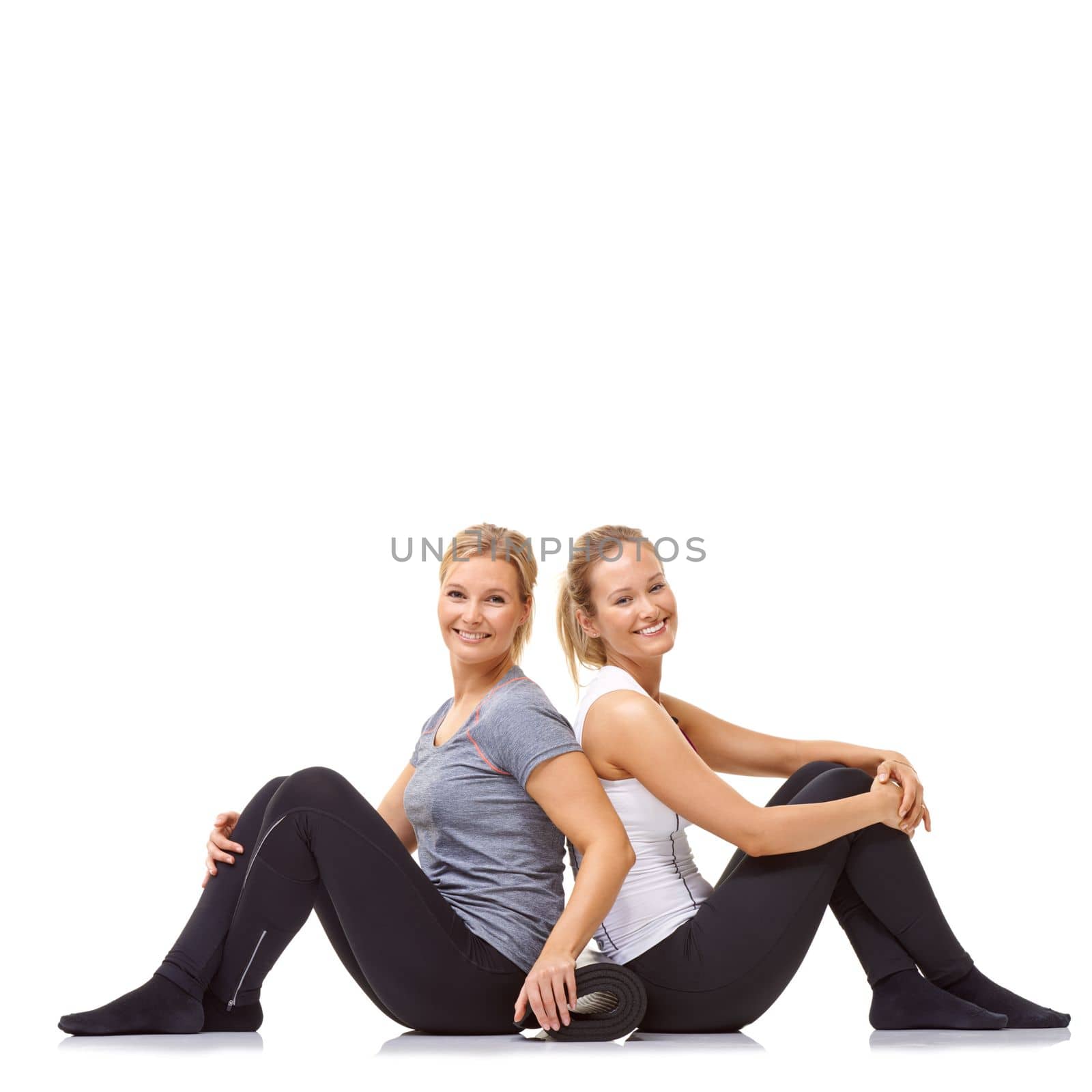 Gym buddies. Two gym friends sitting back to back while isolated on a white background