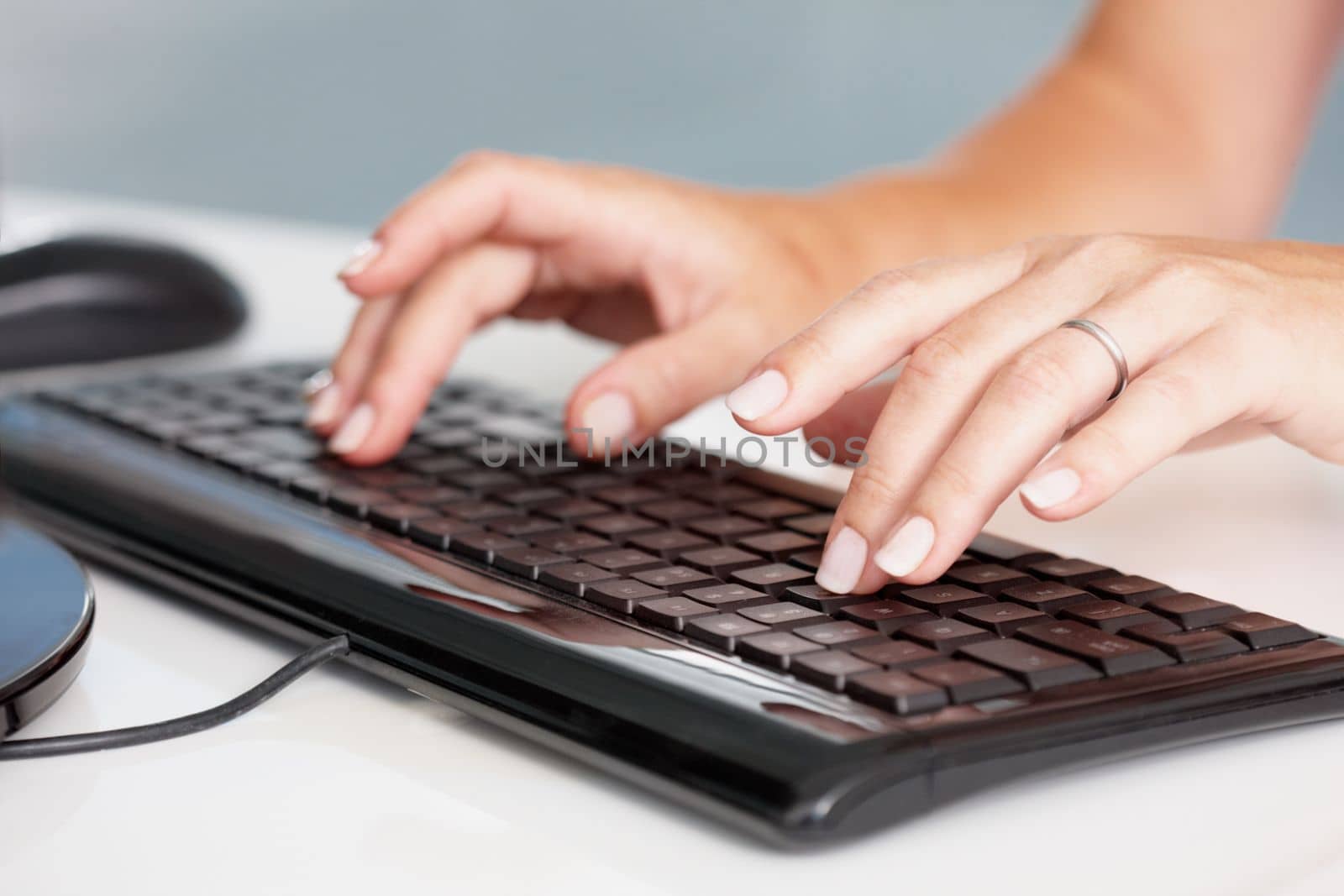 Our clients are in capable hands. A pair of female hands typing on a keyboard. by YuriArcurs