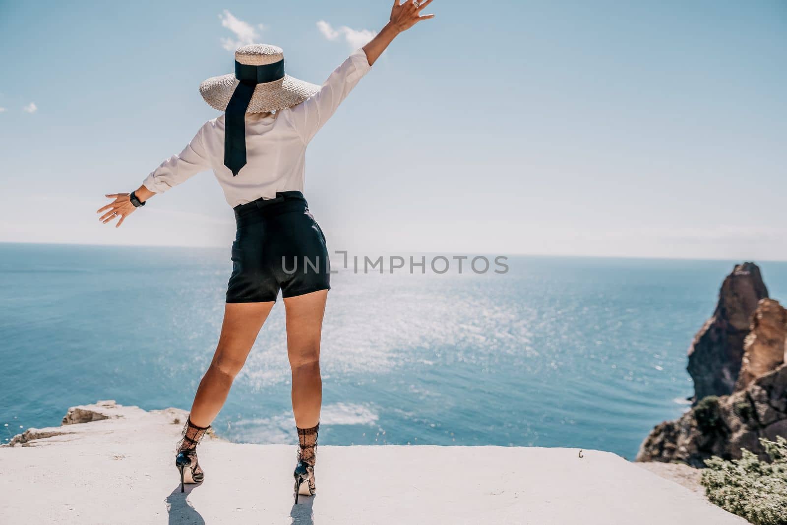 Happy girl doing yoga with laptop working at the beach. beautiful and calm business woman sitting with a laptop in a summer cafe in the lotus position meditating and relaxing. freelance girl remote work beach paradise