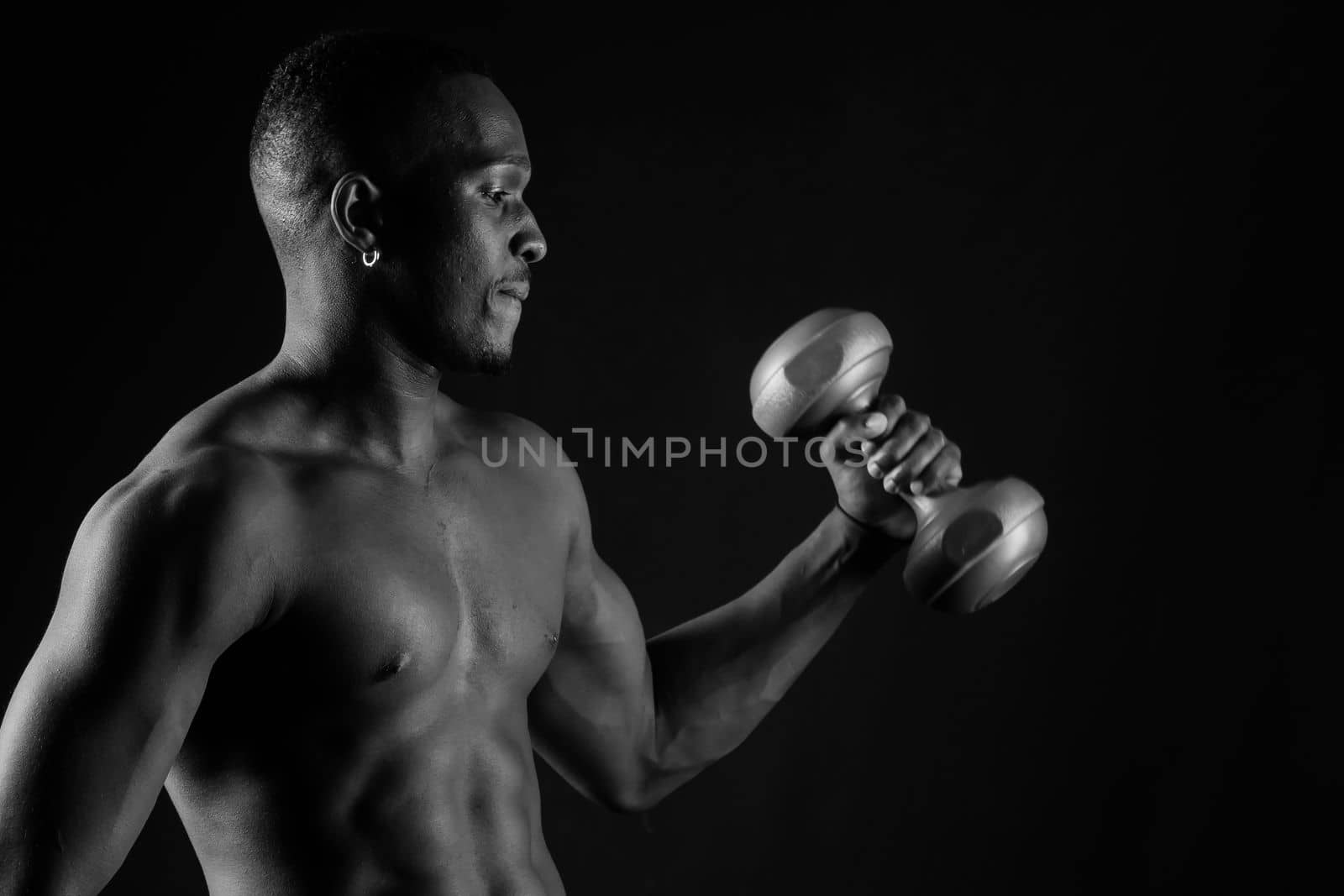 Portrait of happy african man with dumbbells over red background