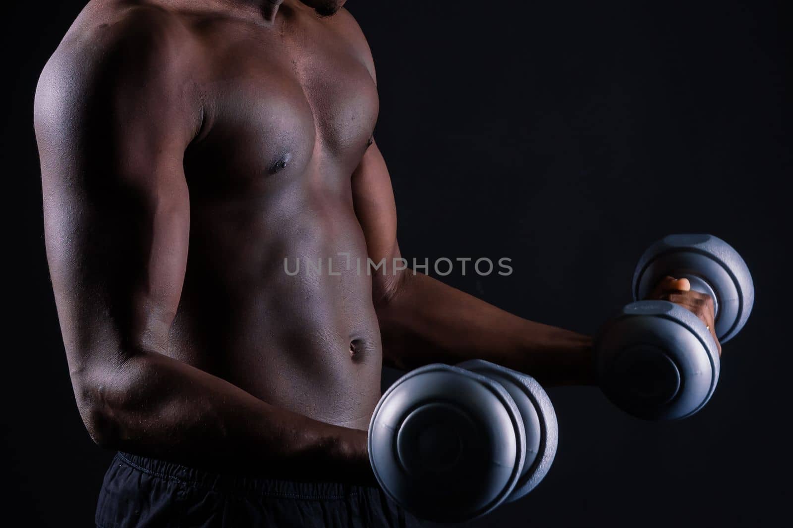 Portrait of a happy african man with dumbbells over red background by Zelenin