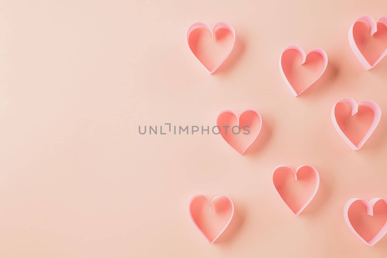 Top view flat lay pink ribbon heart shaped decorative symbol on pastel pink background, love romance concept, banner design with copy space, Mother, Woman day, Happy Valentines Day