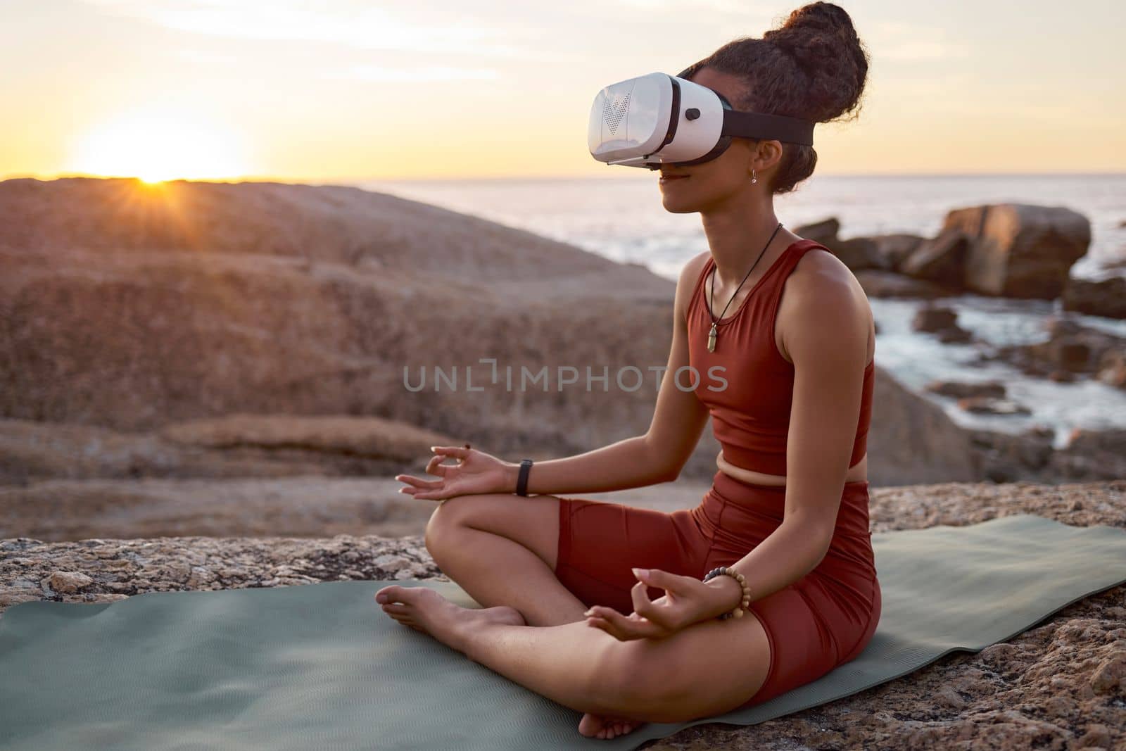 Woman, metaverse or vr headset in yoga meditation by beach, ocean waves, sea water in mental health support, zen app or 3d peace ai. Lotus, relax or wellness person on virtual reality chakra software by YuriArcurs