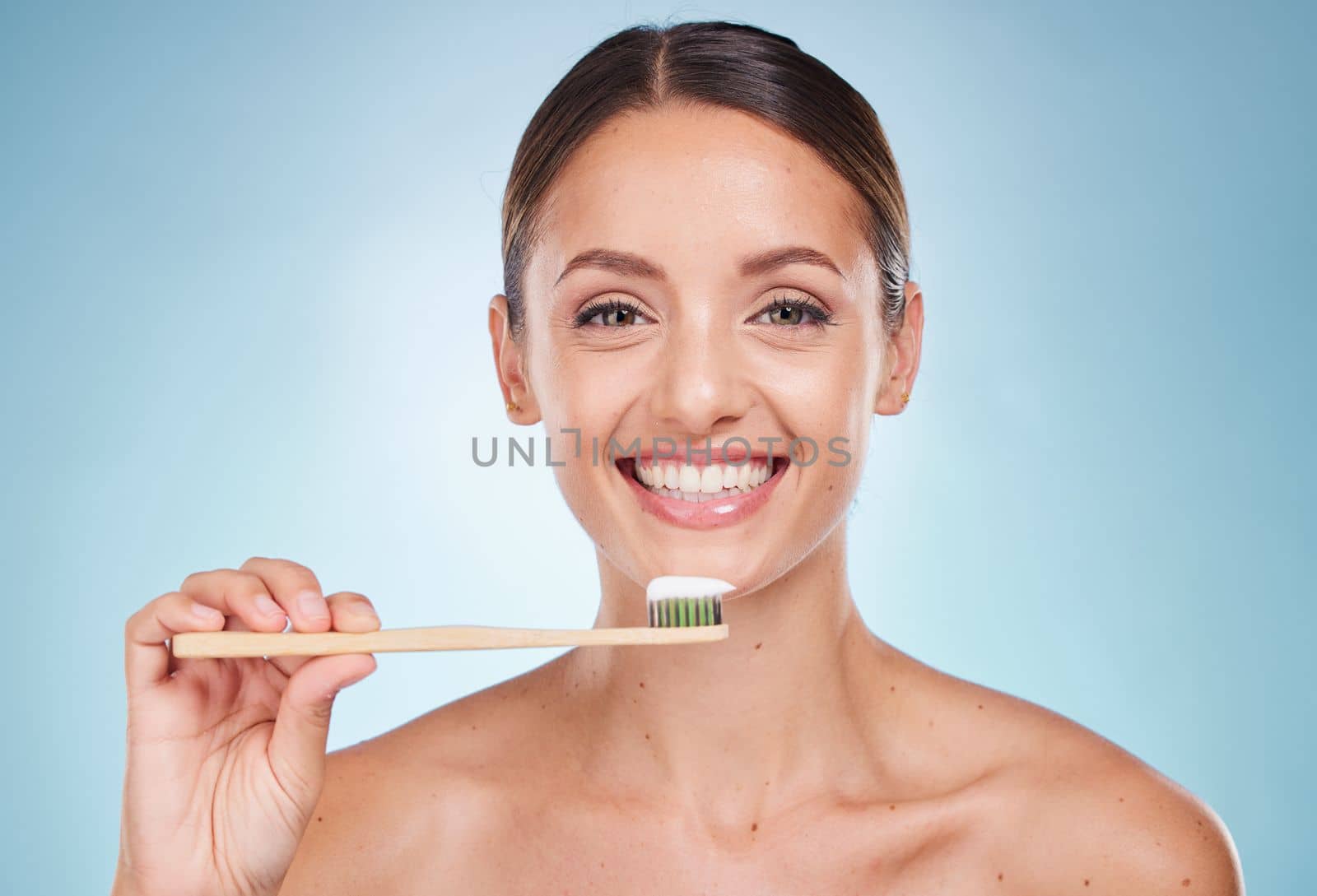 Brushing teeth, dental and woman with toothbrush for teeth whitening and beauty, oral health and fresh breath with studio background. Mouth wellness, Invisalign portrait and clean with bamboo brush. by YuriArcurs