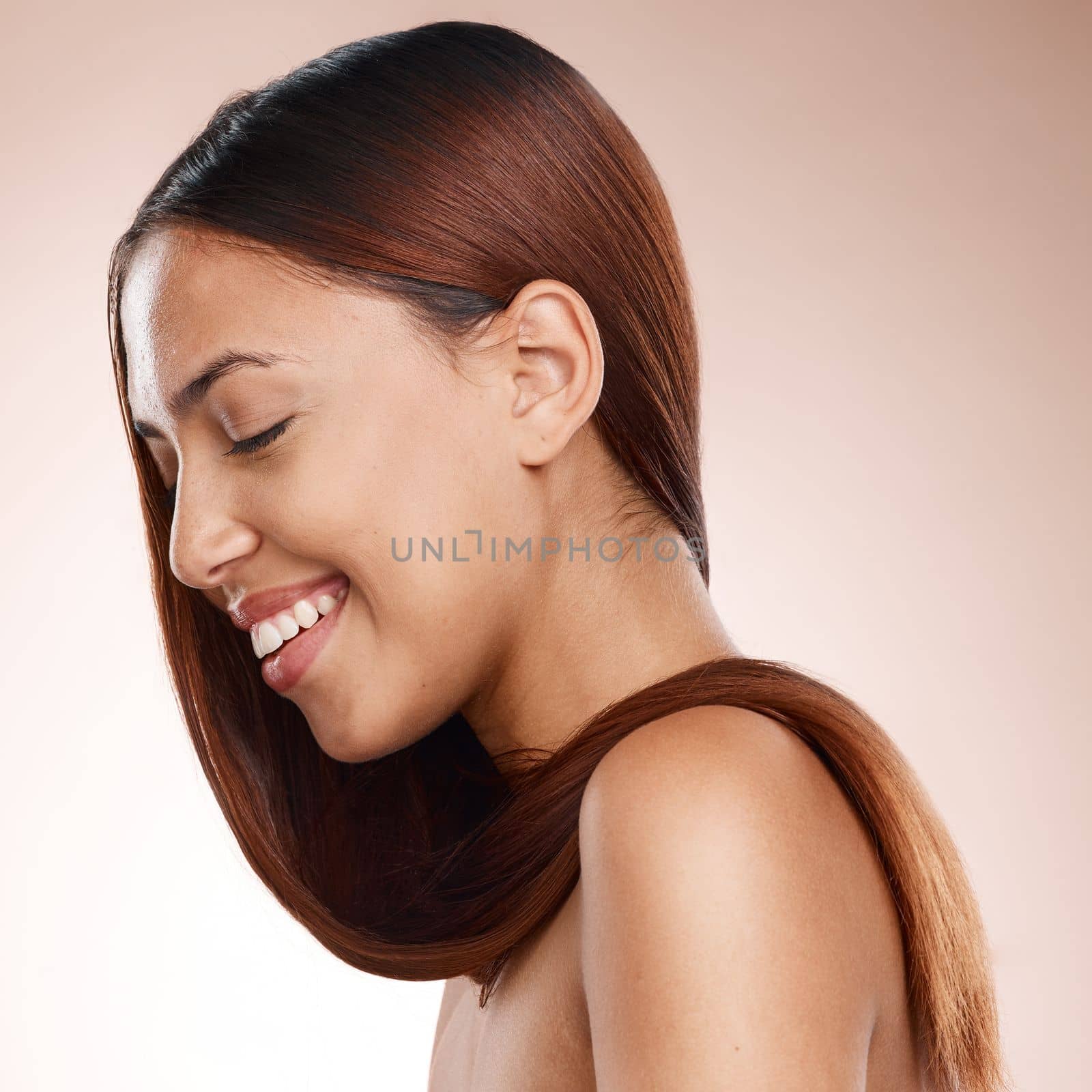 Beauty, hair care and woman with shine, salon treatment and smile on studio background. Female, girl and hairstyle for cosmetics, luxury and natural care for wellness, self care and happy on backdrop by YuriArcurs