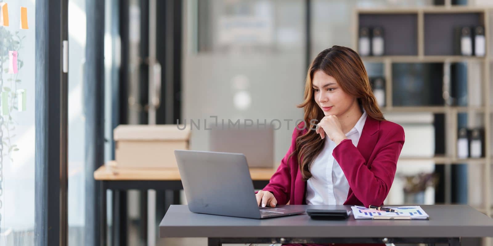 Beautiful Asian Business woman working at home office and analyze financial report document. Accounting and Finance concept. by itchaznong