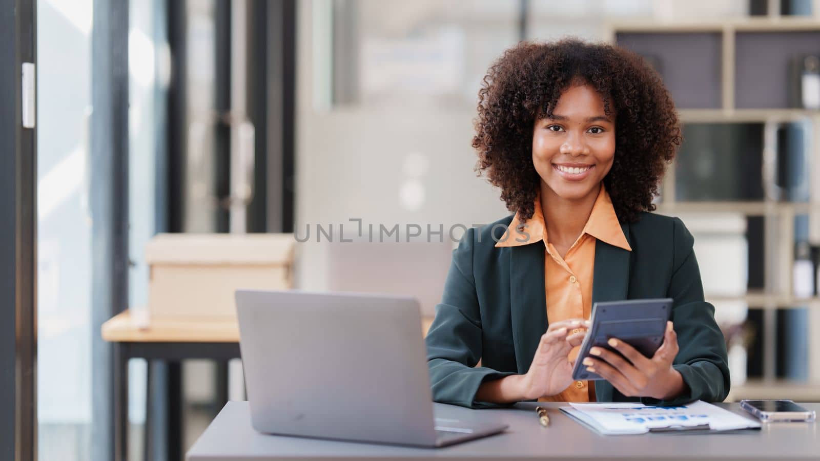 Accountant black woman working on laptop and do document, tax, exchange, accounting and Financial advisor concept by itchaznong