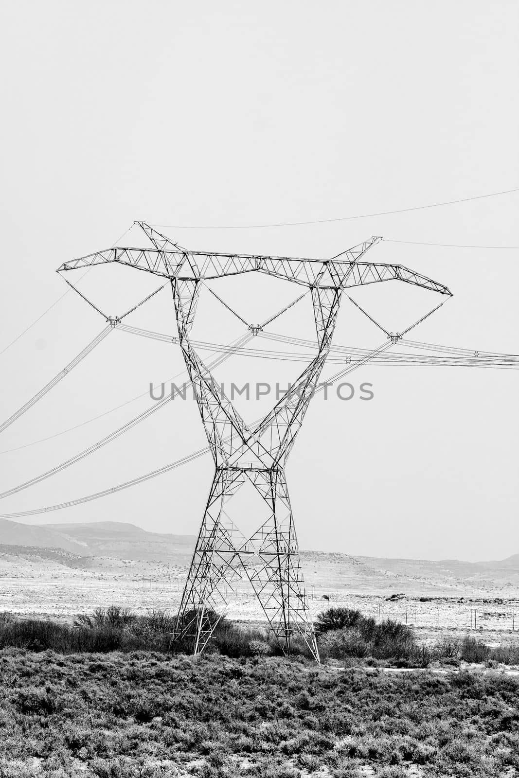 Delta type pylon on a power transmission line. Monochrome by dpreezg