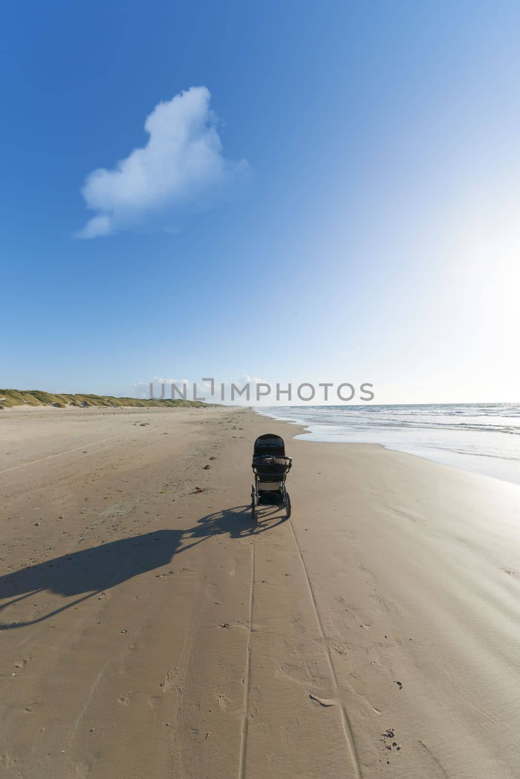 Abandoned. An abandoned baby stroller on a beach in Jutland, Denmark. by YuriArcurs