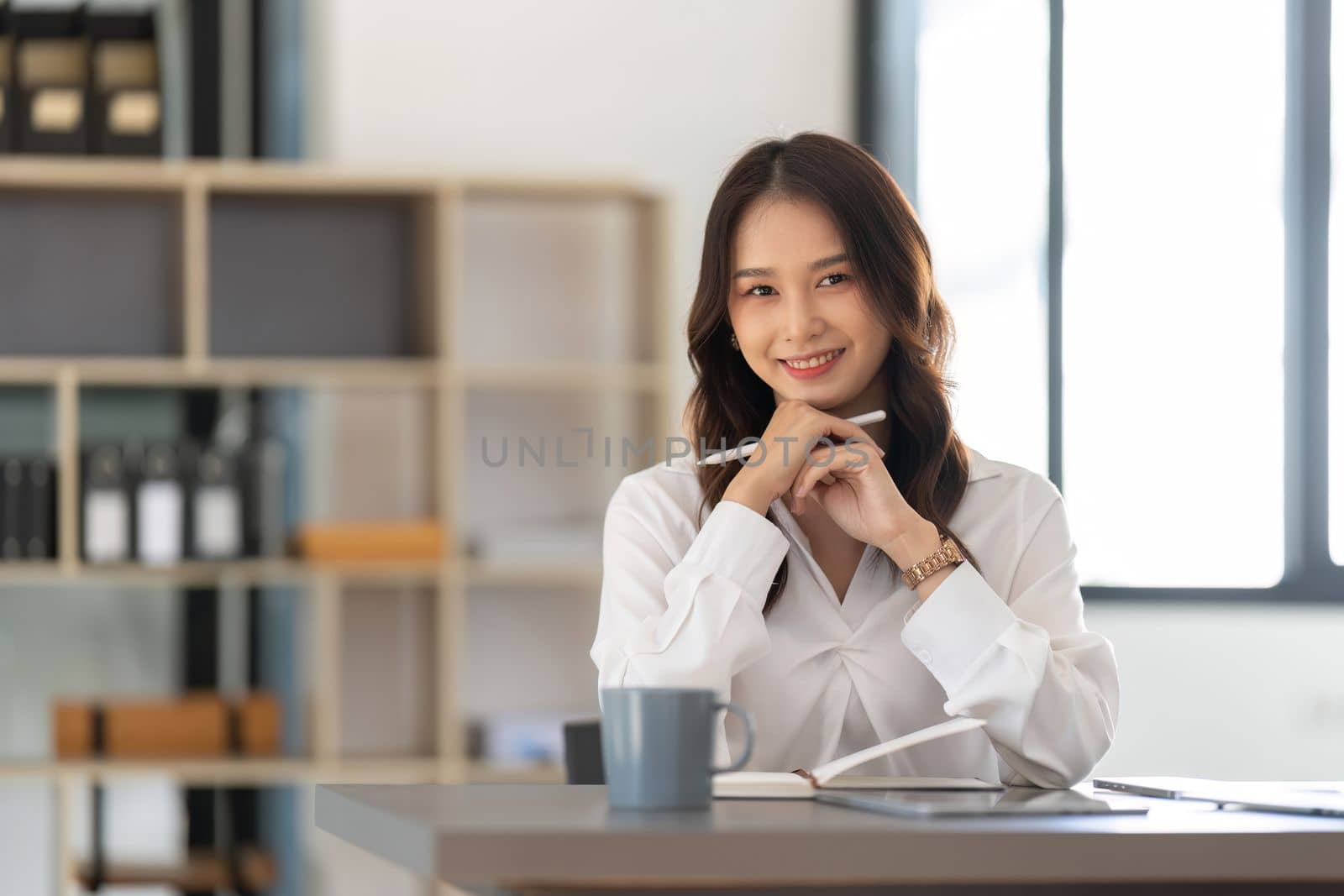 Young businesswoman working on laptop in office.
