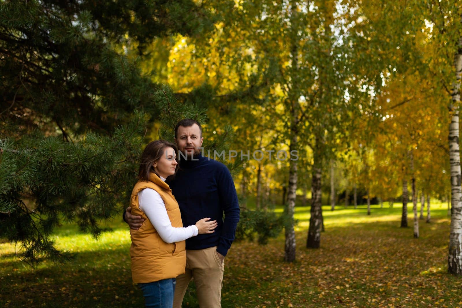 happy mature family couple on the background of autumn forest.