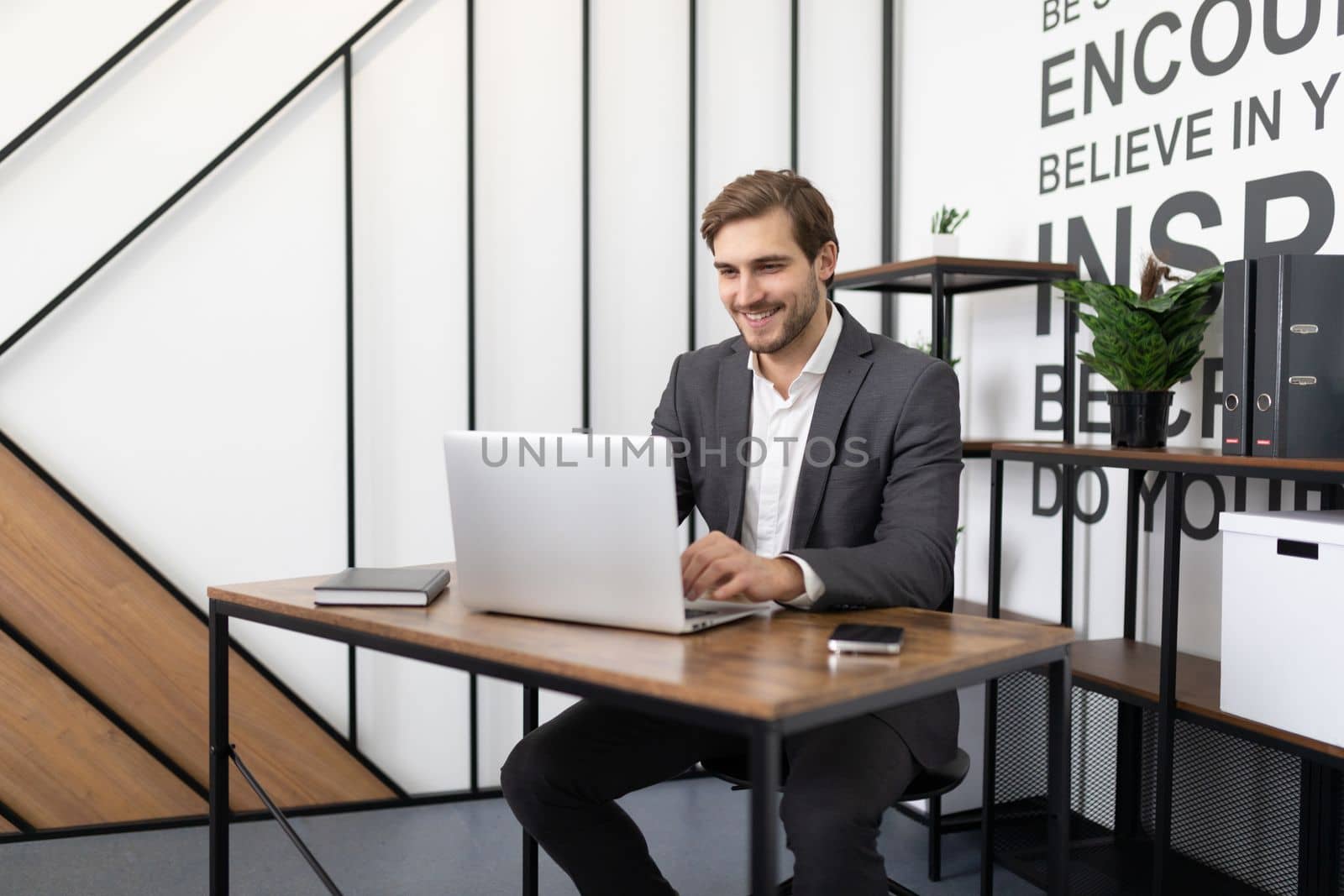 businessman working on laptop in office.