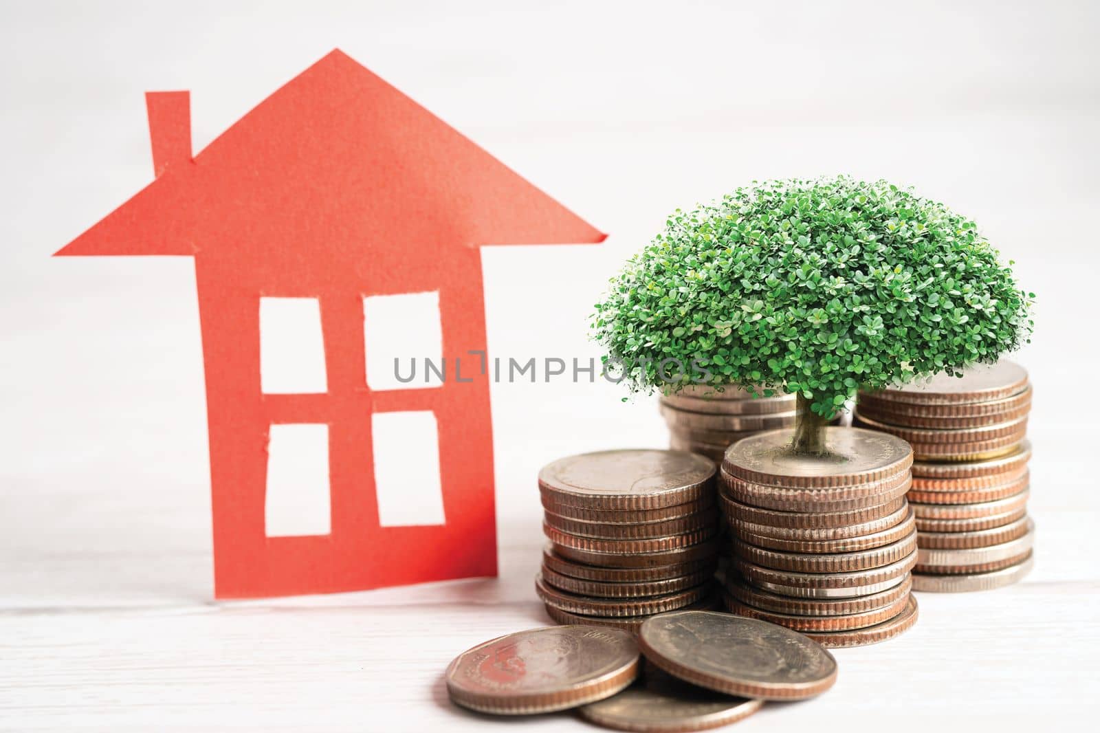 House model with growing plant on stack of coin money, home loan, saving plan, installment payment finance and banking concept.