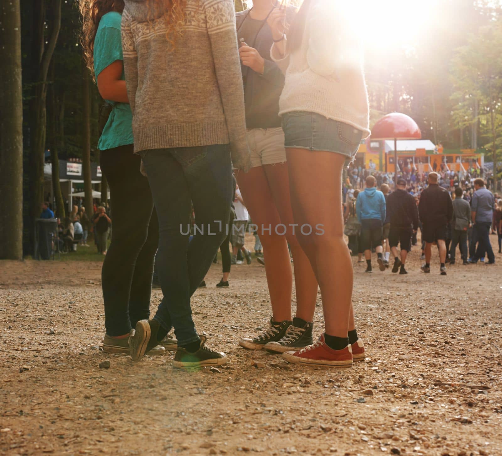 Festival fun. a group of friends standing outdoors. by YuriArcurs