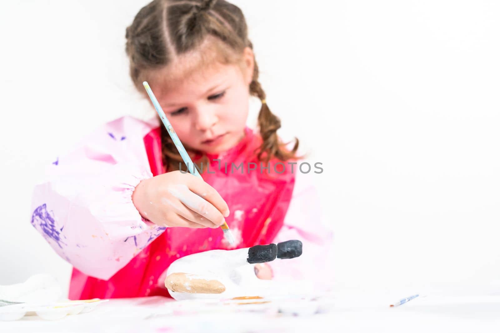 Little girl working on her art project for distance learning at home during COVID-19 pendemic.