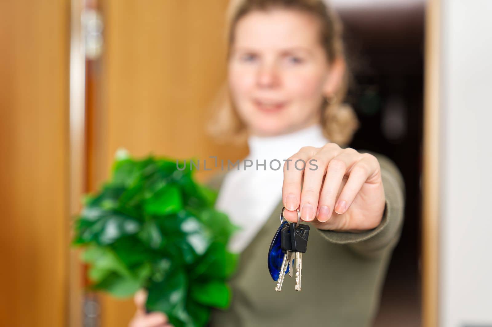 Starting new life. Overjoyed woman hold keys from new apartment or home. new life starts now by PhotoTime