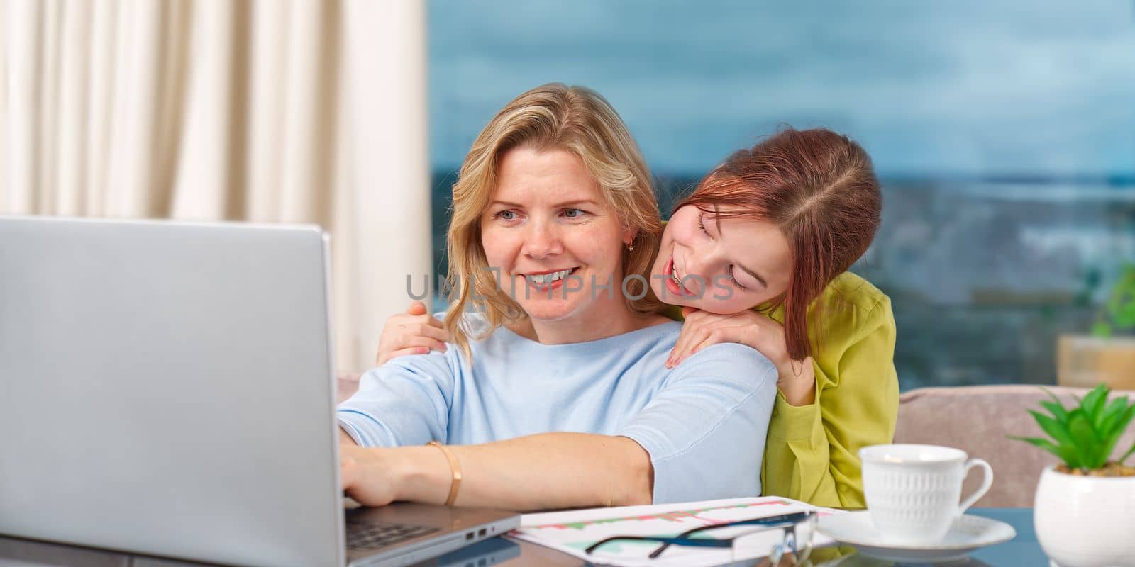 Mother with daughter working from home. Businesswoman mother woman with daughter trying to working by PhotoTime