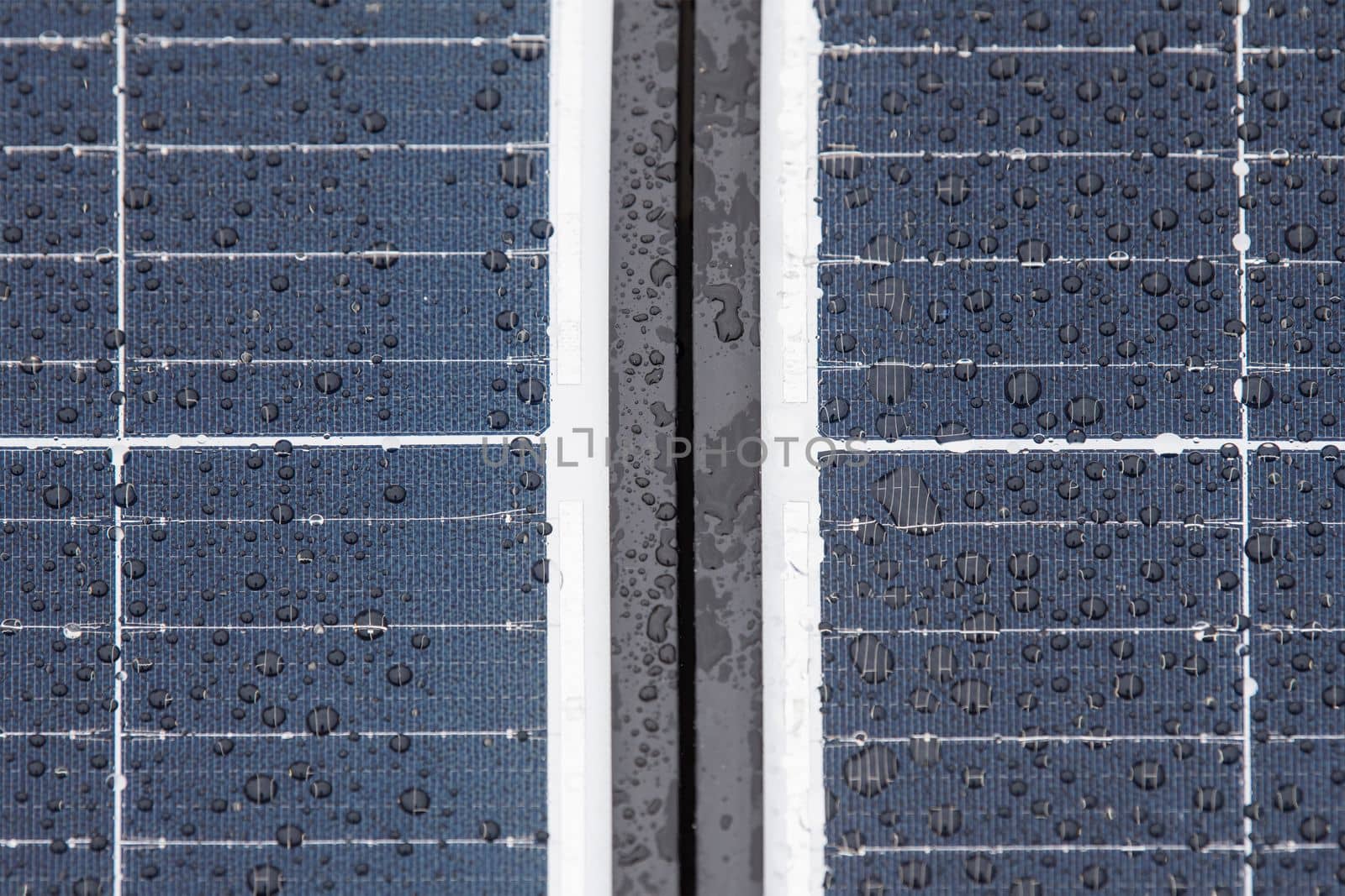 Solar panel in winter. Solar panels are covered with snow on the roof of the building, the use of modules in difficult weather conditions. Electricity production in winter, with copy space.